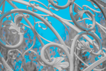 white forged plant ornament against blue skyの写真素材