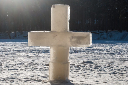 ice christian cross on frozen lakeの写真素材