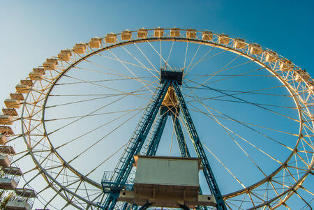White ferris wheel against blue skyの写真素材