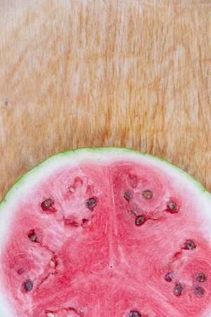 Sliced watermelon on wooden board, viewed from above.の写真素材