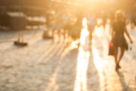 City commuters. High key blurred image of workers going back home after work. Unrecognizable faces, bleached effect.の写真素材