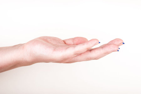 Female hand on white in a gesture of holding something, giving, or taking
