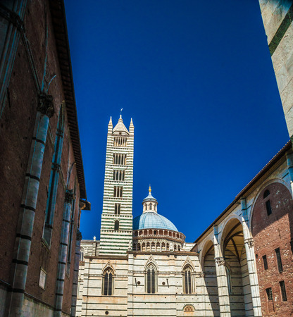 Bell tower of the cathedral in Siena, Italyの写真素材