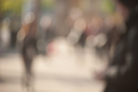 People walking down the street in the evening, beautiful light at sunset. The photo is purposely...