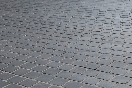 Old cobbled road in sunlight. Abstract texture for travel in Europe. の写真素材