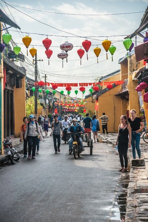 HOI AN, VIET NAM - FEBRUARY 4, 2015: Unidentified tourists walking on a decorated street of Hoi An ancient city, Da Nang province, Vietnam. Hoi An is recognized as a World Heritage Site by UNESCO.のeditorial素材