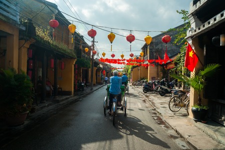 HOIAN, VIETNAM - FEBRUARY 4, 2015:  Cycle rickshaws carry passengers in Hoian ancient city, Danang province, central Vietnam. Hoi An is one of the main tourist attractions in Vietnam.のeditorial素材