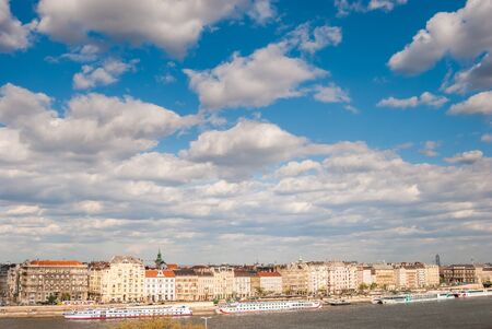 Panorama of the left bank of Danube river in Budapest, Hungary. Beautiful cityscape with houses and clouds.の写真素材