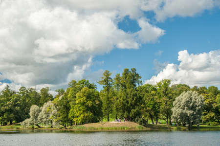 Beautiful landscape in Tsarskoye selo near Saint-Petersburg, Russia. Russian nature with the lake and green trees under blue cloudy skies in summertime. Bright seasonal image - perfect as background.の写真素材