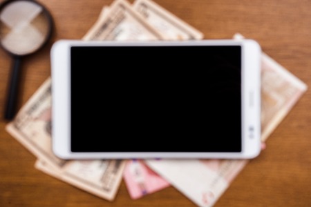 Gadget on wooden desk - concept of application analytics, online research and web search. Background for advertising and blogs.の写真素材