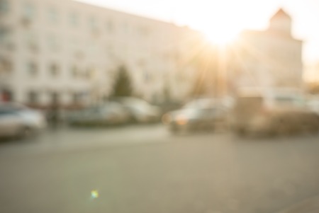 Traffic at sunset, defocused image of a road lit with warm light of setting sunの写真素材
