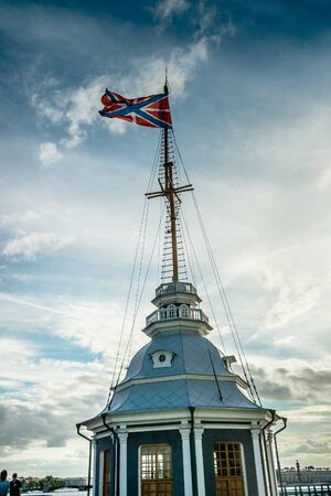 The Russian Fortress flag flatters over Peter and Paul fortress in Saint Petersburg, Russia. Flag against cloudy sky at dawn.の写真素材