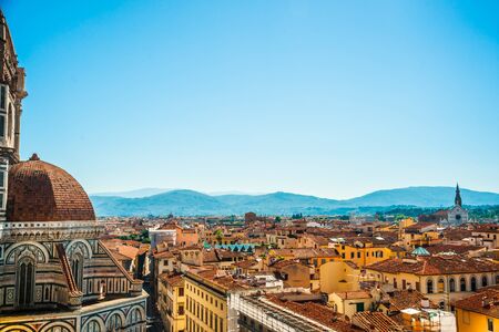 Cityscape of Florence on sunny day with multiple tiled roofs and historical monuments.の写真素材