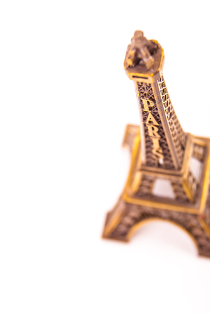 Photo of little model of Eiffel Tower isolated on white. Image of travel in France and symbol of Paris.の写真素材