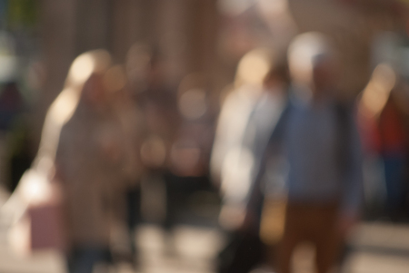 People walking down the street in the evening, blurredの写真素材