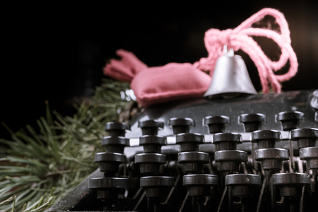 Vintage typewriter with red Christmas tree decoration. Photography for blog and creative banners, or hero image. Symbol of blogging, writing, internet activity and creativity.の写真素材