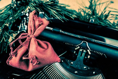 Vintage typewriter with red Christmas tree decoration. Photography for blog and creative banners, or hero image. Symbol of blogging, writing, internet activity and productivity.の写真素材