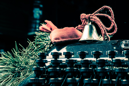 Vintage typewriter with red Christmas tree decoration. Photography for blog and creative banners, or hero image. Symbol of blogging, writing, internet activity and creativity.の写真素材