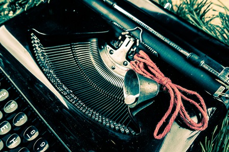 Vintage typewriter with red Christmas tree decoration. Photography for blog and creative banners, or hero image. Symbol of blogging, writing, internet activity and creativity.の写真素材