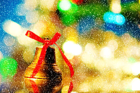 christmas bell near decorated treeの写真素材