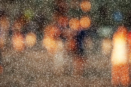 Winter city commuters with snow. Blurred image of workers going back home after work. Unrecognizable faces, bleached effect.の写真素材