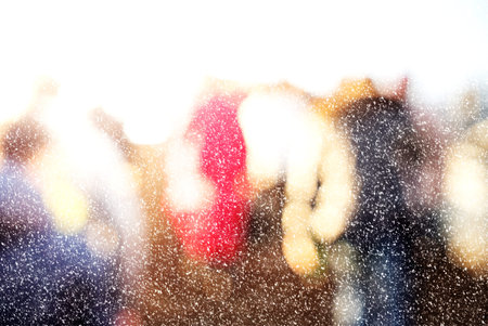 Winter city commuters with snow. Blurred image of workers going back home after work. Unrecognizable...