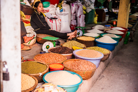 NINH BINH, VIETNAM - JANUARY 23, 2015: Different cereal and corn in round containers in a market in Ninh Binh. Vietnam. In Vietnam Agriculture's share of economic output has declined in recent years.のeditorial素材