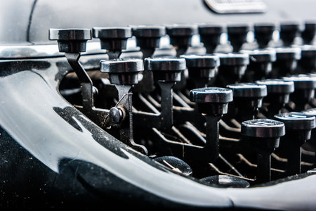 Old typewriter on table. Closeup photo of a vintage typewriter.