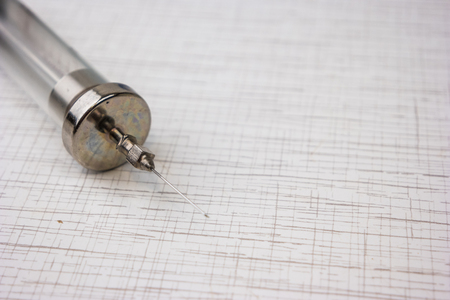 Vintage syringe on white table, medical equipmentの写真素材