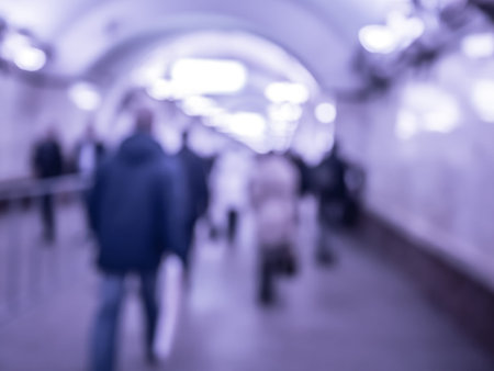 City commuters in subway. Unrecognizable humans moving through a subway tunnel. Blurred background texture for blog, websites, editorial use ,etc.の写真素材