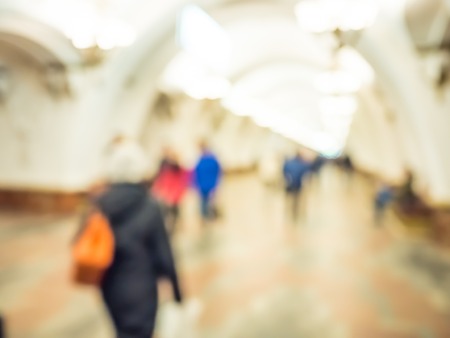 City commuters in subway. Unrecognizable humans moving through a subway tunnel. Blurred background texture for blog, websites, editorial use ,etc.の写真素材