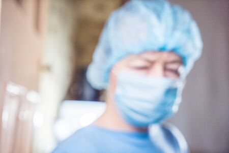 Female dentist with tools staring at a patientの写真素材