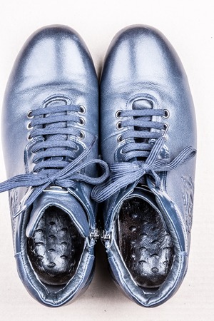 Men's shoes for autumn on light solid background. Blue boots on the ground.の写真素材