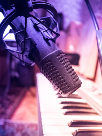 Electronic piano with microphone. Musical background image. Recording studio equipment.