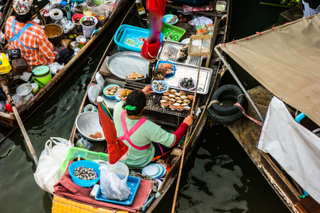 Colorful trader's boats in a floating market in Thailand. Floating markets are one of the main cultural tourist destinations in Asia.の写真素材