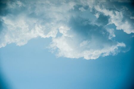 Clouds in the sky. Beautiful vintage photo with a vignette. Can be used as abstract background for different design projects.の写真素材