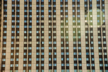 Downtown corporate business district architecture: white office buildings against blue sky with clouds and sun lightの写真素材