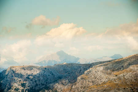 Beautiful landscape with rocky mountains and clouds on the western part of Mallorca island, Spain.  Tramuntana mountains with green bushes. Tourist trekking destination in Spain.の写真素材