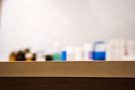 Blurred image of medical drugs on table. Medical vials unfocused background.の写真素材