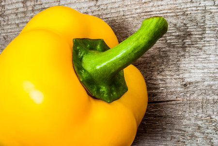Yellow Bell Pepper on woodの写真素材