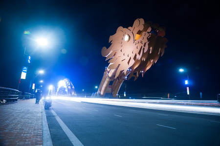 Dragon Bridge at night in Da Nang, Vietnam. Beautiful photo of modern city in night illumination.の写真素材