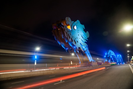 Dragon Bridge at night in Da Nang, Vietnam. Beautiful photo of modern city in night illumination.の写真素材