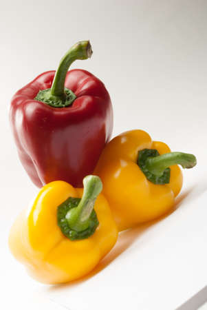 Red and Yellow Bell Peppers on a white backgroundの写真素材