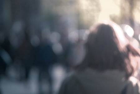 People walking down the street in the evening, beautiful light at sunset. The photo is purposely...