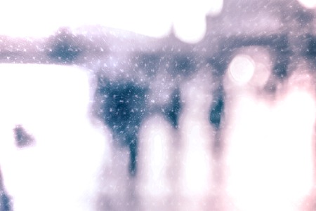 Winter city commuters with snow. Blurred image of people walking on the street. Defocused figures of people with snowing effect and frost.の写真素材