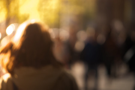 People walking down the street in the evening, beautiful light at sunset. The photo is purposely...