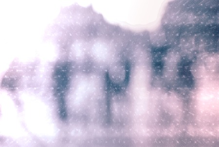 Winter city commuters with snow. Blurred image of people walking on the street. back home after work. Defocused figures of people with snowing effect and frost.の写真素材