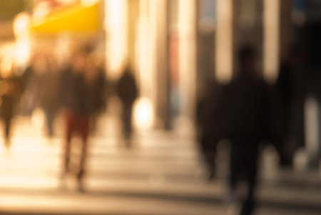 People walking down the street in the evening, beautiful light at sunset. The photo is purposely...