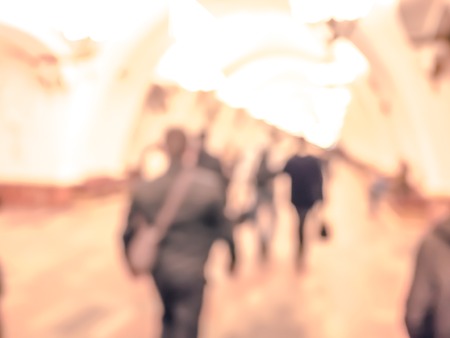 City commuters in subway. Unrecognizable humans moving through a subway tunnel. Blurred background texture for blog, websites, editorial use ,etc.の写真素材