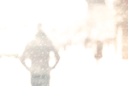 Winter city commuters with snow. Blurred image of people walking on the street. Defocused figures of people with snowing effect and frost.の写真素材